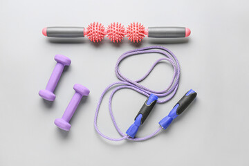 Sports equipment with body roller on grey background