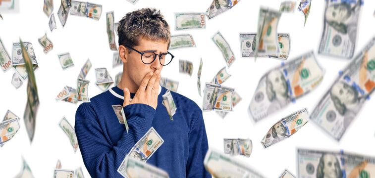 Young handsome man wearing casual clothes and glasses bored yawning tired covering mouth with hand. restless and sleepiness.