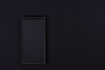 Black blank notebook on black background with copy space. Black Friday banner, place for text