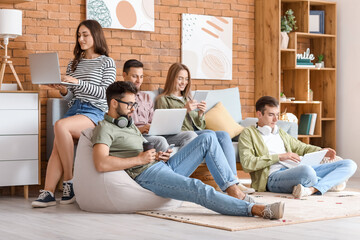 Students with modern devices studying online at home