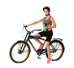 Naklejka premium Female cyclist drinking water on white background