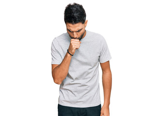 Young man with beard wearing casual grey tshirt feeling unwell and coughing as symptom for cold or bronchitis. health care concept.