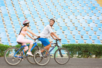 Sporty young couple riding bicycles at the stadium © Pixel-Shot