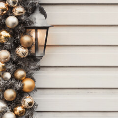 House new year decorations in gold and silver colors. Background christmas wall with street lamp