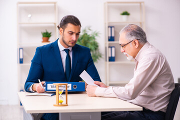 Young male lawyer and old man in testament and time management c