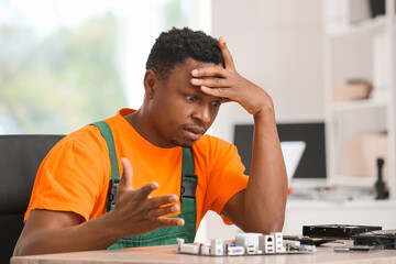 Stressed technician repairing PC in service center