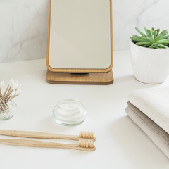 Zero waste concept. Set of eco friendly bathroom accessories - bamboo toothbrushes, cotton buds, natural hairbrush, mirror and linen napkines. Sustainable lifestyle.