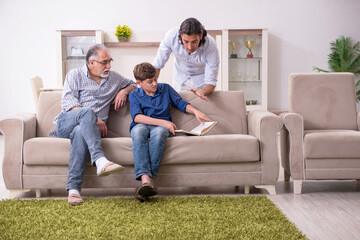 Boy and his father and his grandfother indoor