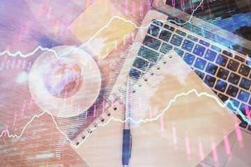 Double exposure of forex chart drawing over table background with computer. Concept of financial research and analysis. Top view.