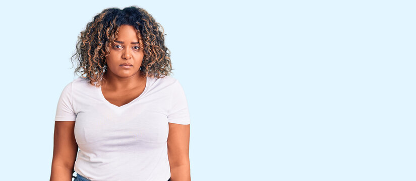 Young african american plus size woman wearing casual clothes depressed and worry for distress, crying angry and afraid. sad expression.
