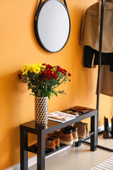Stylish interior of modern hall with autumn flowers