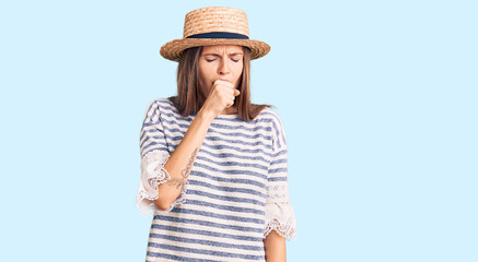 Beautiful caucasian woman wearing summer hat feeling unwell and coughing as symptom for cold or bronchitis. health care concept.