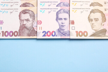 Ukrainian money on light blue background, flat lay. Space for text