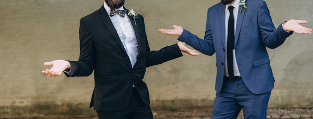 Newlywed stylish gay couple on their happy wedding day. Equality concept.