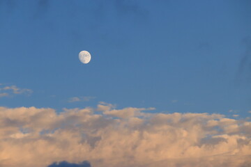 View of the evening sky with clouds and moon