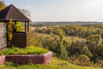 Summer garden gazebo on the edge of the hill with a magnificent view of nature
