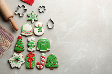 Kitchen utensils near Christmas tree shape made of delicious gingerbread cookies on marble table,...