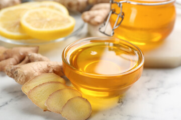 Honey and ginger on white table, closeup. Natural cold remedies