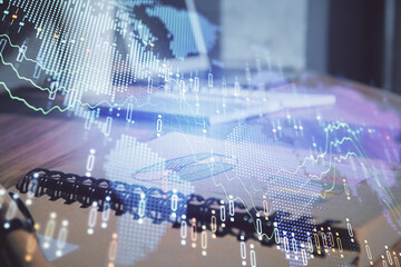 Double exposure of financial graph drawings and desk with open notebook background. Concept of forex market