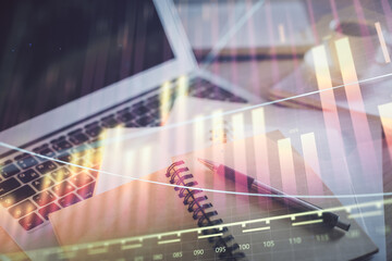 Double exposure of financial chart drawing and desktop with coffee and items on table background....