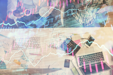 Fototapeta na wymiar Double exposure of man and woman working together and financial chart hologram drawing. market analysis concept. Computer background. Top View.