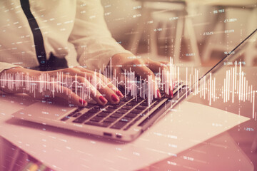 Multi exposure of woman hands typing on computer and financial graph hologram drawing. Stock market analysis concept.