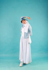 Fashion portrait of young beautiful asian muslim woman with wearing hijab on blue background