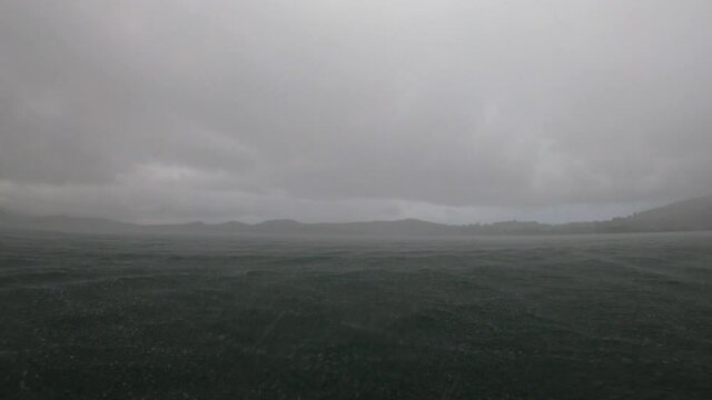 heavy rain over the sea view from a boat cloudy day Martinique