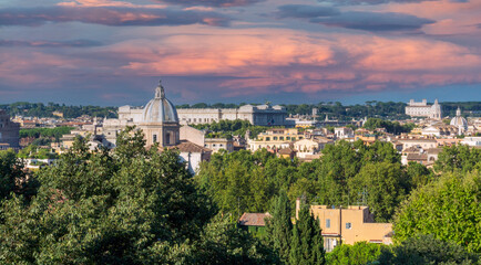 Naklejka premium Panorama over Rome city in Italy, from high angle viewpoint during sunset and pink skies. Architecture and travelling concept.