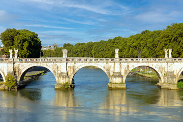 Fototapeta na wymiar Bridge over tiber river next to castel de angelo in rome, italy.