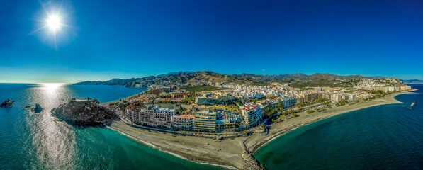 Fototapeta premium Aerial view of is a centuries-old Arab fort San Miguel Castle. The Rocks of San Cristobal extends to sea. Almunecar on Spain's south coast, known for beaches like Velilla, San Cristobal and Del Mar