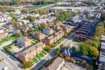 Aerial view of regentrified Woodberry neighborhood in Baltimore Maryland with brick townhomes,...