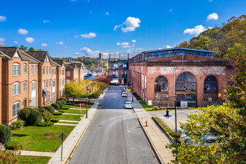 Aerial view of regentrified Woodberry neighborhood in Baltimore Maryland with brick townhomes, former foundry factory converted to luxury apartments  - obrazy, fototapety, plakaty