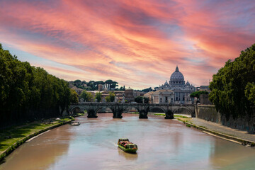 Tourist boat on tiber river canal in rome italy infront of st peters basilica during twilight with pink skies above. Travelling and cityscape concept.