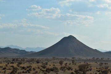 Fototapeta na wymiar Volcano and mountains in desert at sunset, Saudi Arabia, KSA, on the way between Jeddah and Medina 