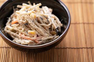 Burdock salad on a wooden luncheon mat