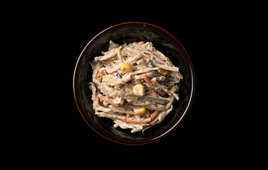 Burdock salad on a black background