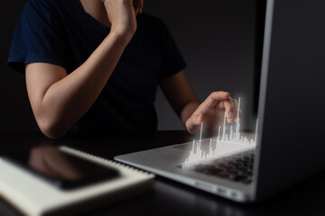 Fototapeta na wymiar Woman using laptop with chart hologram effect.