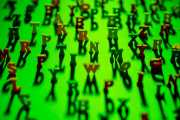 Fototapeta na wymiar ABC pattern. Letters background in green. Letters are arranged chaotically. Background consists of 3D letters. Focusing on center frame. Character are blurred around edges. Pattern topic of education