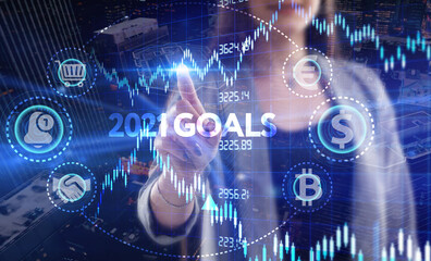 Business, Technology, Internet and network concept. Young businessman working on a virtual screen of the future and sees the inscription: 2021 goals