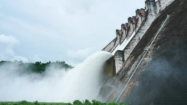 Floodgate with flowing water through gate. Open the springway Khun Dan Prakan Chon Dam thailand