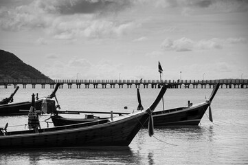 Thailand longtail fishing boat at Chalong bay. Phuket. Black and white