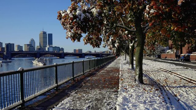 Autumn snow on Charles River with Boston skyline pan