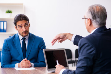 Young male candidate employee meeting with old recruiter