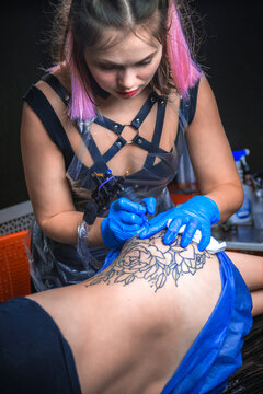 Professional tattoo artist making tattoo art in tattoo studio