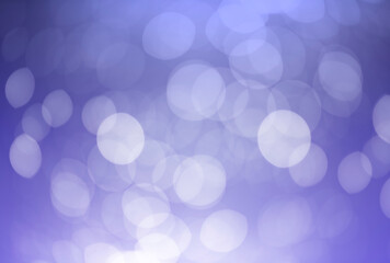 White bokeh defocus glitter blur on dark purple background. bokeh abstract background.