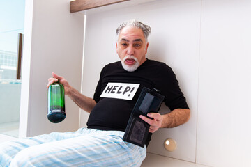 Old man drinking wine in the bedroom