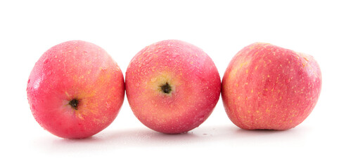 Three red apples with water drops on white background
