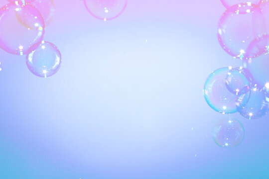 Beautiful fresh colorful pink soap bubbles floating in the air. Natural clear bubbles abstract background.
