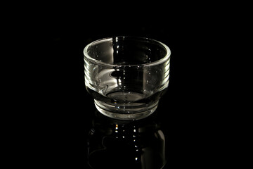 Empty glass on black background